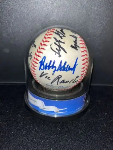 Autographed baseball in display case featuring Yankees greats signed by legends