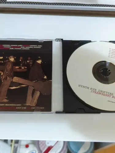 Open CD case of Nynth Ave Drifters Strawberry Road Signed music album