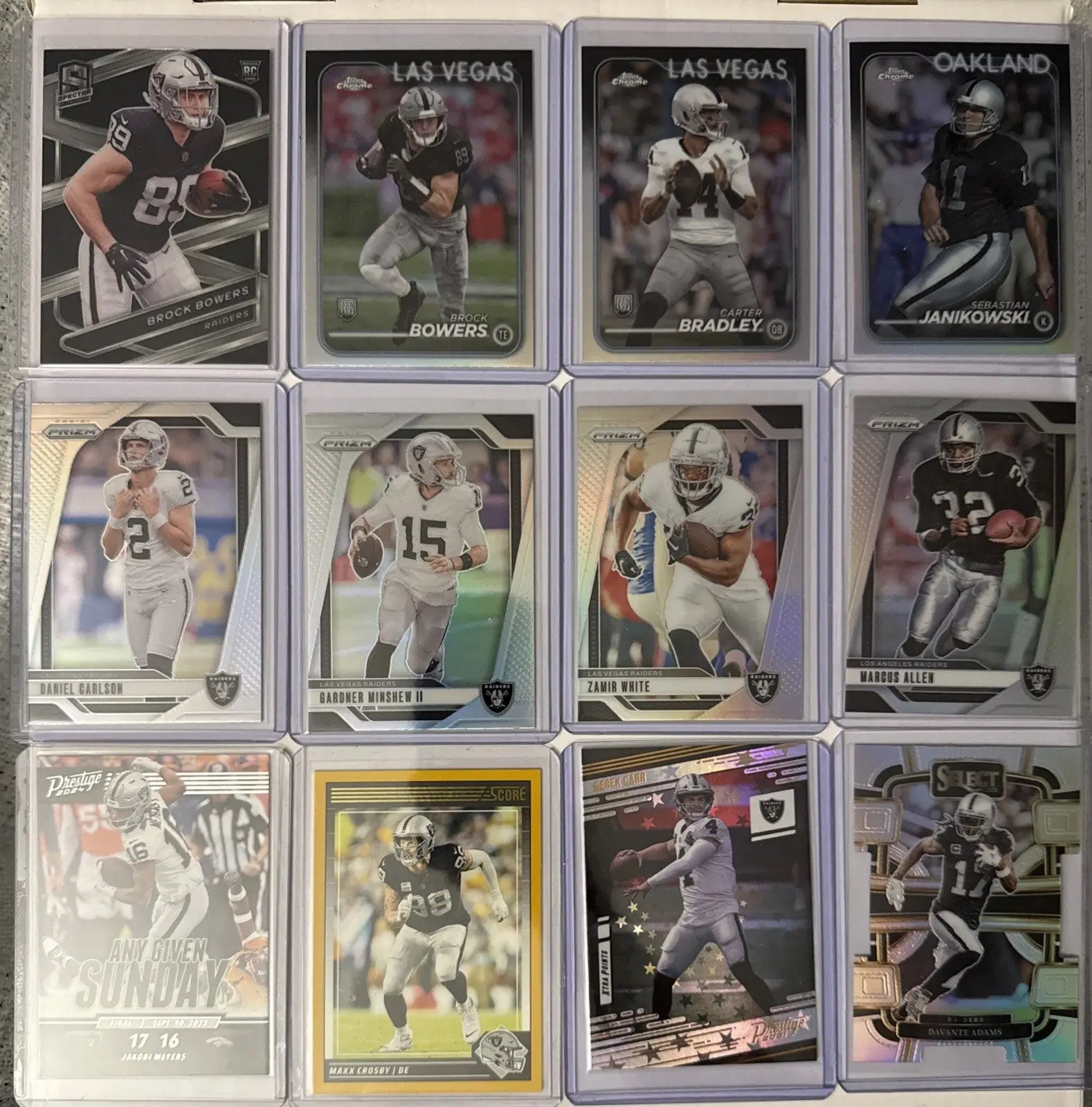 Collection of twelve Oakland Las Vegas Raiders football trading cards featuring rookies and inserts