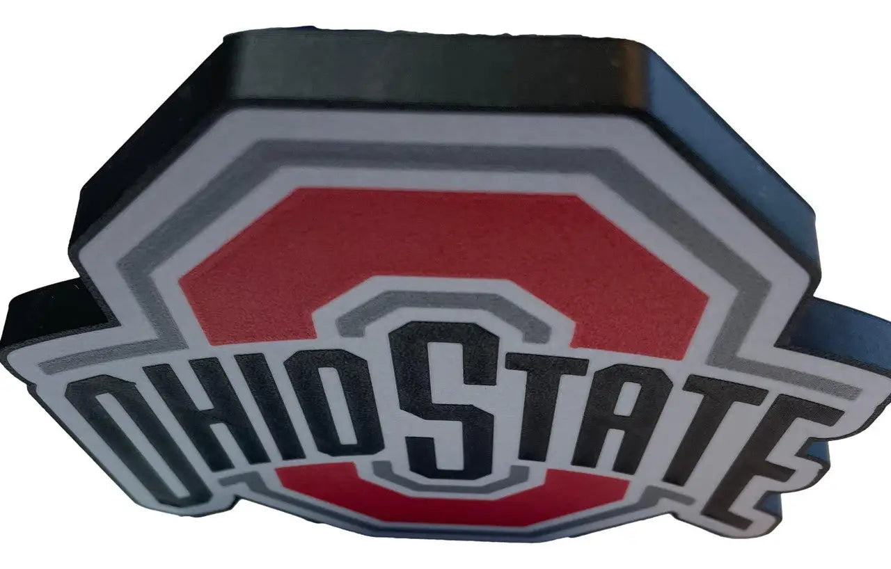 Ohio State Buckeyes logo magnet or pin displayed on Ohio State Buckeyes sign