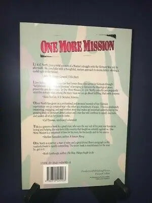 Book with camouflage background featuring Oliver North and David Roth autographs