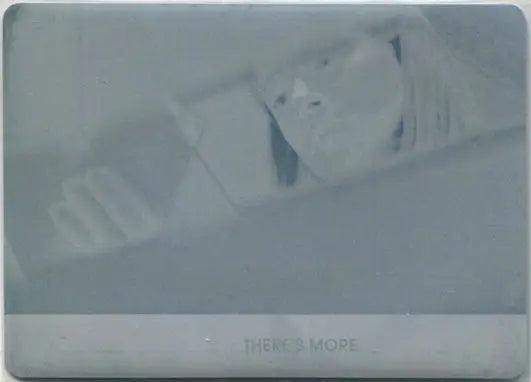 Partially unwrapped chocolate bar with bite featuring Orphan Black Season printing plate