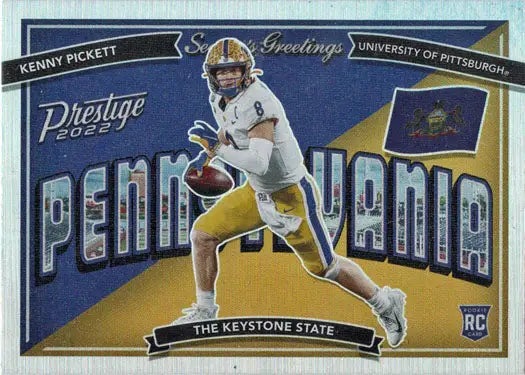 Football player in a white and gold uniform running with the ball on a trading card insert