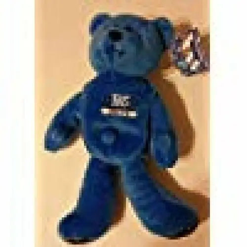 Blue plush teddy bear with tag featuring original gloss and Peyton Manning memorabilia