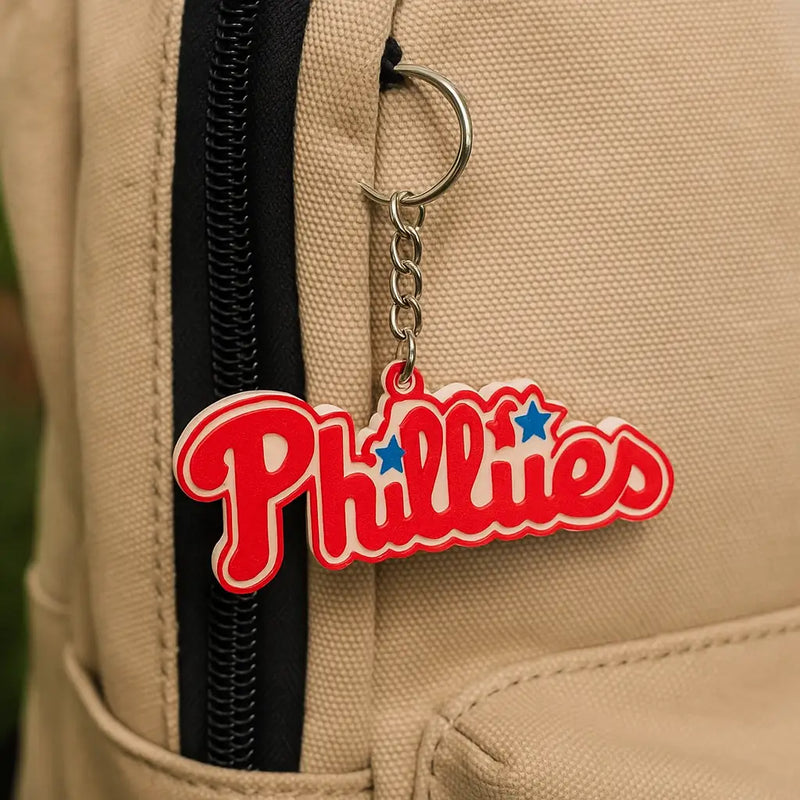 Red and white Phillies key ring with blue stars on beige backpack, perfect MLB fan gift
