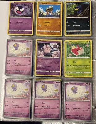 Pokémon card binder collection with nine trading cards displayed in a binder collection