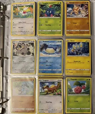 Pokémon card binder collection with nine trading cards displayed in a binder page