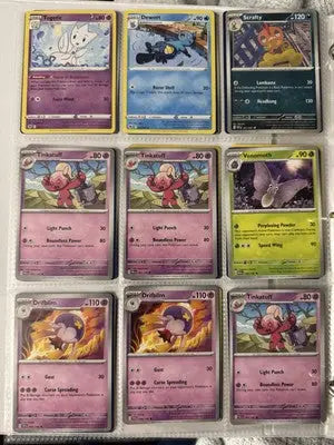 Pokémon card binder collection with nine trading cards displayed in a binder page