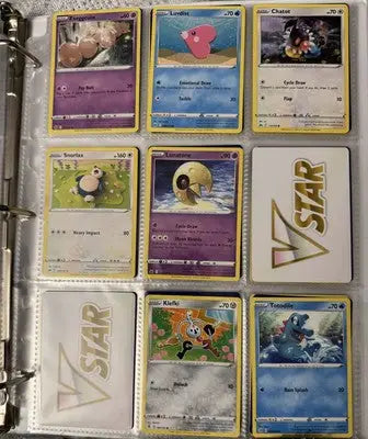 Pokémon card binder collection with nine trading cards including two VSTAR cards