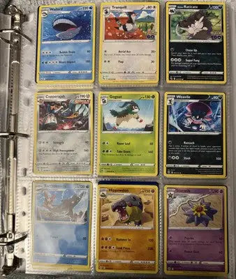 Pokémon card binder collection with nine trading cards displayed in a binder page