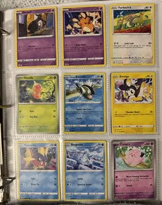 Pokémon card binder collection with nine trading cards displayed in a binder page