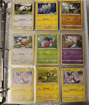 Pokémon card binder collection with various trading cards displayed inside