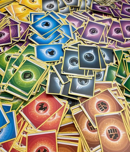 Collection of colorful Pokémon TCG energy cards in a pile for trading and gameplay