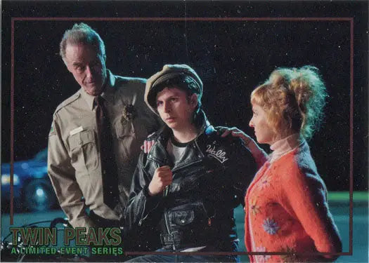 Three people in dim light admiring Rittenhouse 2019 Twin Peaks trading cards