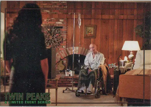 Elderly person in wheelchair in rustic setting with Rittenhouse 2019 trading cards