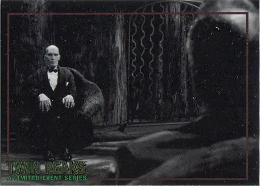 Bald man in tuxedo sitting in chair with Rittenhouse 2019 trading cards display