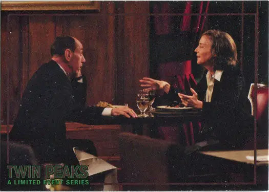 Two people conversing at a restaurant table over Rittenhouse 2019 trading cards