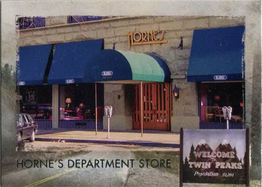 Storefront of Horne’s Department Store with blue awnings and a Welcome to Twin Peaks sign
