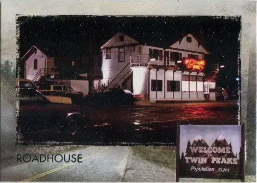 Two-story white building with Roadhouse sign at night in Twin Peaks trading cards
