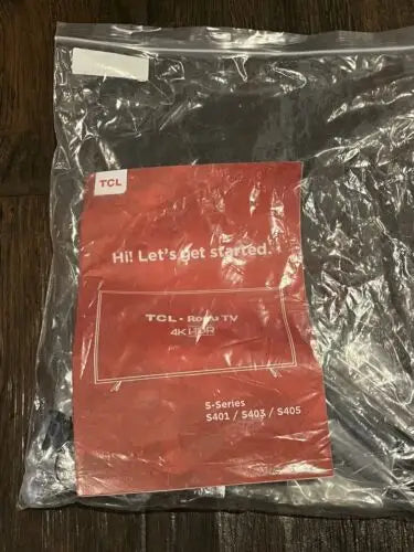 TCL Roku TV manual in a plastic bag for S-Series S401 S403 S405 TV stand instructions