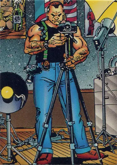 Muscular tattooed man in tank top using camera on tripod for Triton Magazine trading card
