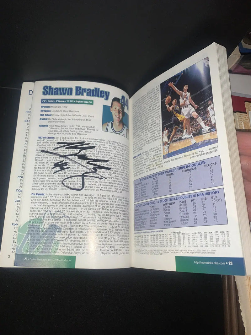 Autographed Shawn Bradley page in 1998 Dallas Mavericks Media Guide collectors item