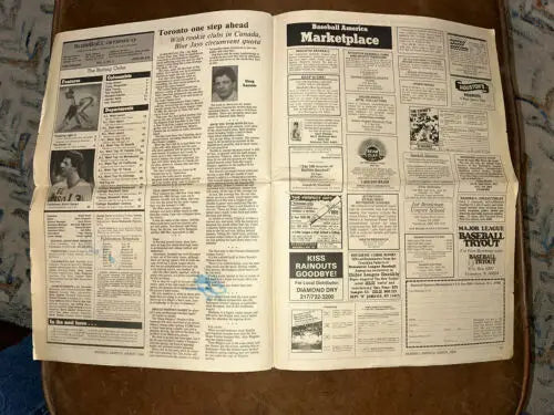 Open Baseball America newspaper featuring Wally Joyner and Todd Worrell autographs