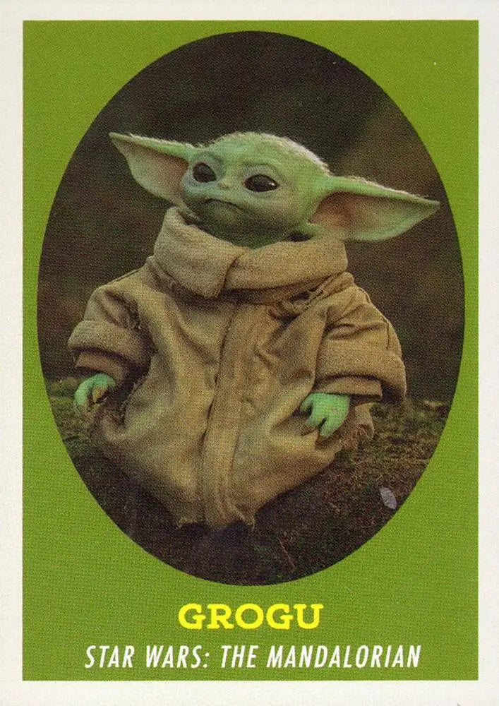 Small green alien Grogu with large ears in tan robe from Star Wars trading cards
