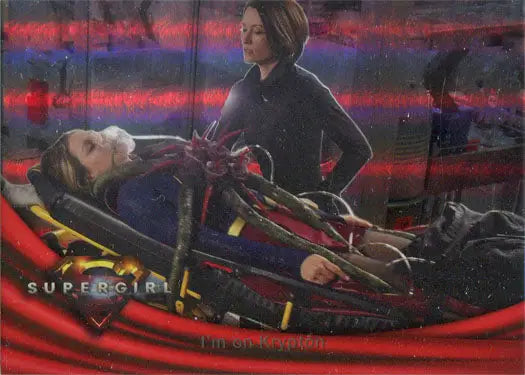 Injured person on a stretcher with a figure nearby on Supergirl Rainbow Foil Board Card