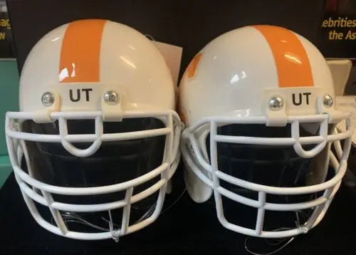 Two white football helmets with orange stripes for Tennessee Volunteers helmet hood ornament
