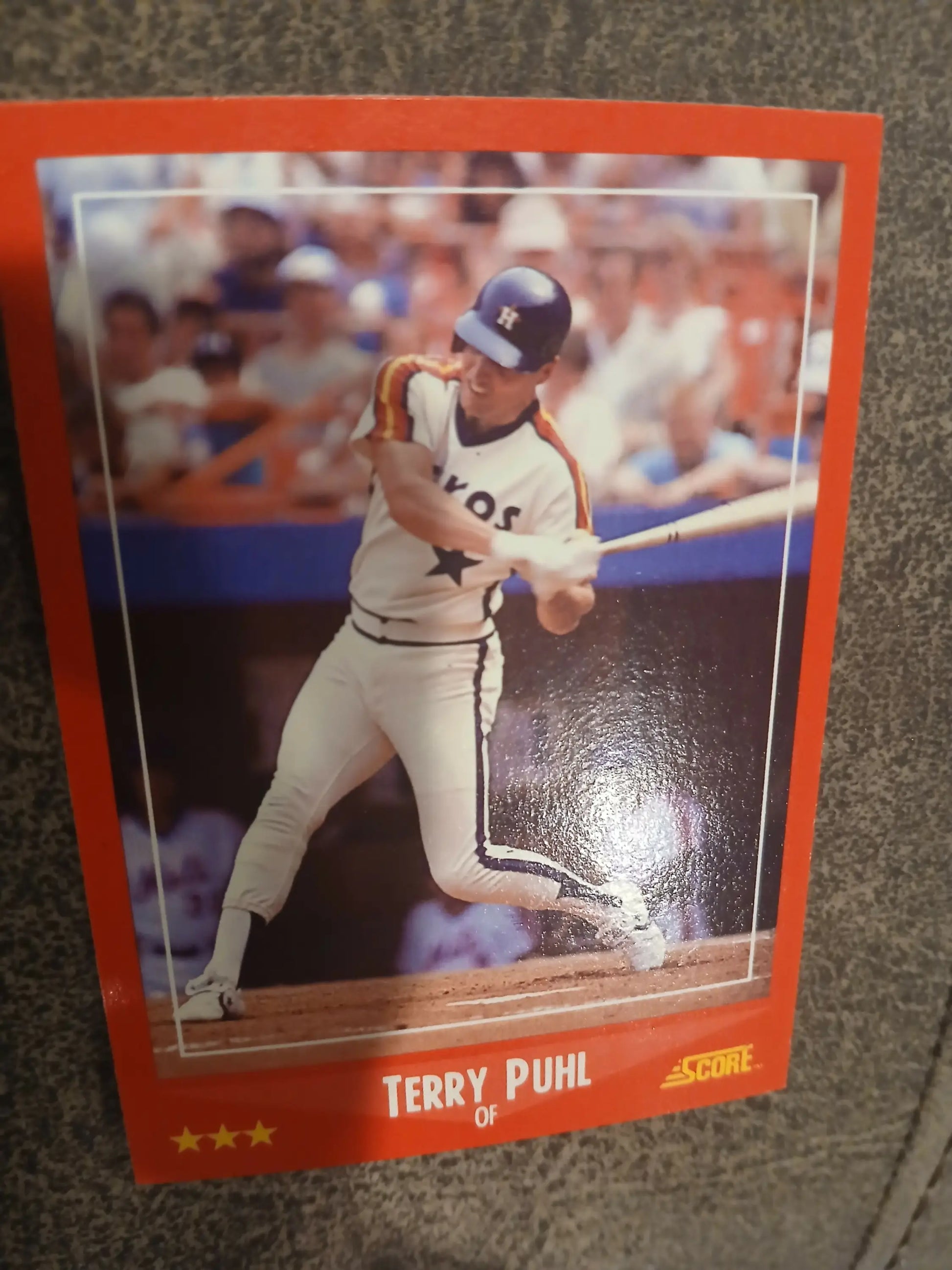 Terry Puhl baseball card showcasing a Houston Astros player swinging a bat in white uniform