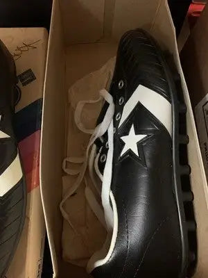 Black and white Dorsett Converse football cleats with star for Dallas Cowboys fans