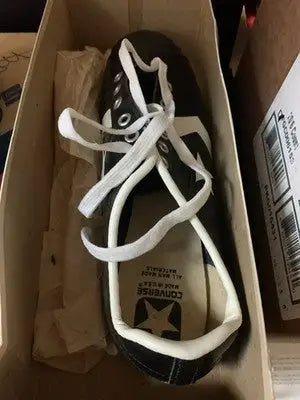 Black Tony Dorsett Converse football cleats with white laces and star logo in box