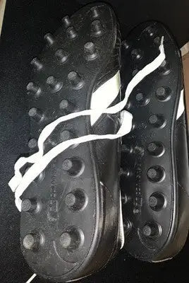 Black athletic cleats with white laces and stripes, Dorsett Converse football shoes