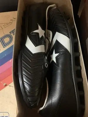 Black and white Tony Dorsett Converse football cleats in box, Dallas Cowboys style