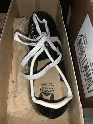 Black Tony Dorsett Converse football cleats with white laces in box, Dallas Cowboys gear