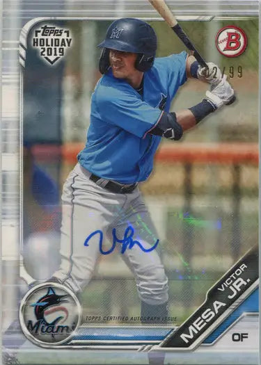 Baseball player in light blue uniform with Victor Mesa Autograph Card from Topps Holiday