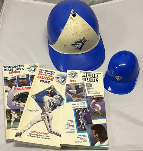 Toronto Blue Jays memorabilia lot featuring helmets and media guides from 1987, 1990, 1992