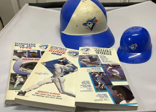 Toronto Blue Jays memorabilia including helmets and media guides from 1987, 1990, 1992