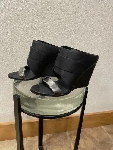 Black wedge sandals with silver straps showcasing edgy sophistication in Vince high heel wedge shoes