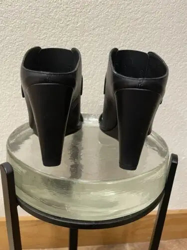Vince women’s high heel wedge shoes featuring a pair of black wedge heel mules