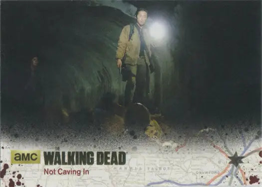 Man holding flashlight in dark mist, featuring Walking Dead Season 4 Gold Foil Parallel