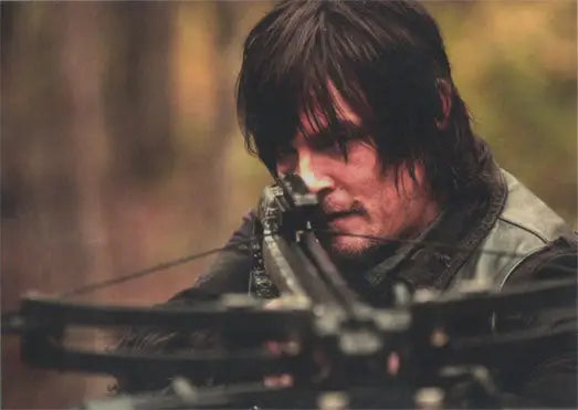 Man with long dark hair aims crossbow on Walking Dead Season 4 Part 2 promo card