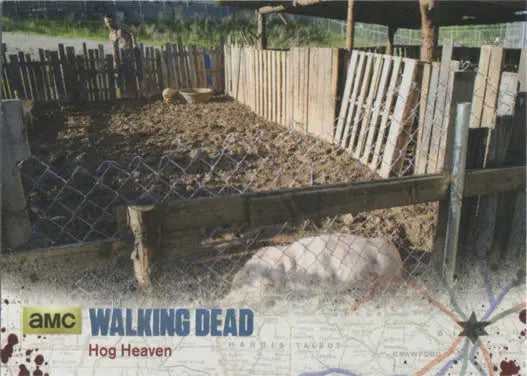 Pig pen with wooden fencing and muddy ground in Walking Dead silver foil parallel card