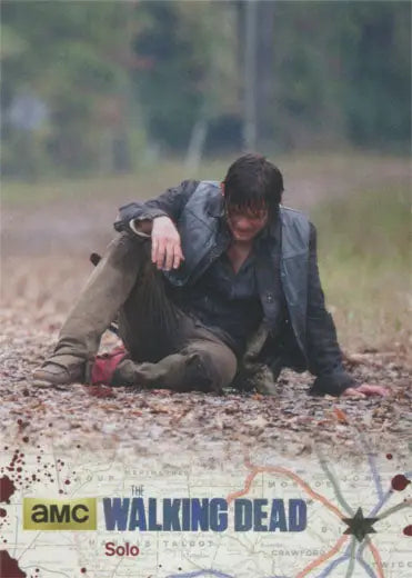 Person in dark clothing on ground covered with leaves, featured in Silver Foil Parallel card