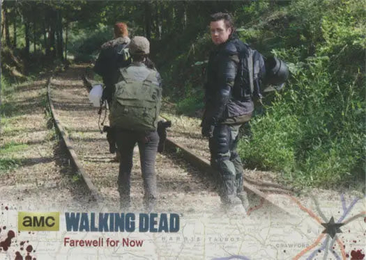 Three people on railroad tracks in woods featured on Walking Dead Silver Foil Parallel Card