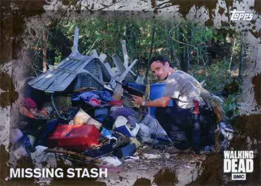 Person in a makeshift outdoor shelter surrounded by supplies in Walking Dead Mud Parallel trading card