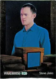 Man in blue collared shirt with wooden box, displaying Warehouse 13 trading cards