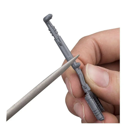 Gray plastic wall anchor and screw held between fingers, part of Warhammer Citadel File Set