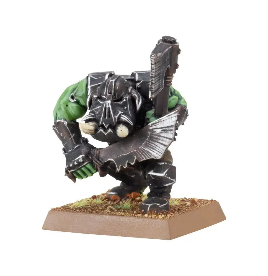 Miniature Orc Boyz figurine in battle stance with hand weapons from Goblin Tribes
